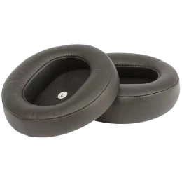 Two oval black leather ear cushions with a soft interior, designed for comfortable headphone use.